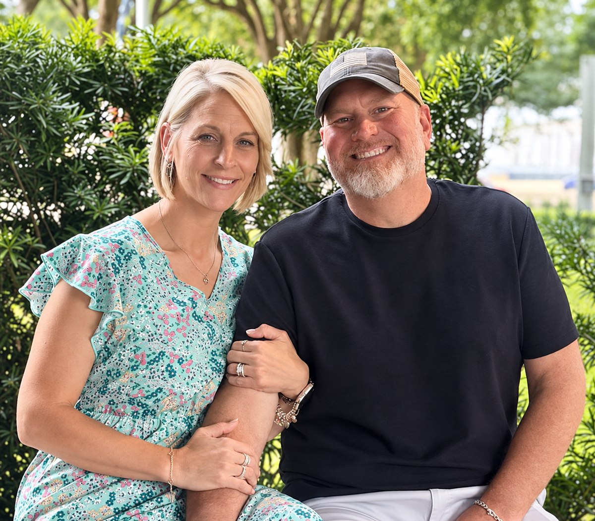 A smiling couple from the Cantrell family seated outdoors